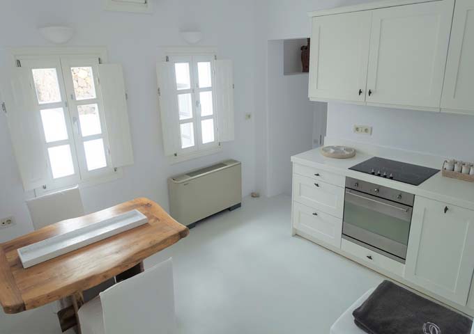The fully-equipped kitchen has a small coffee table, a large stove, and an oven.