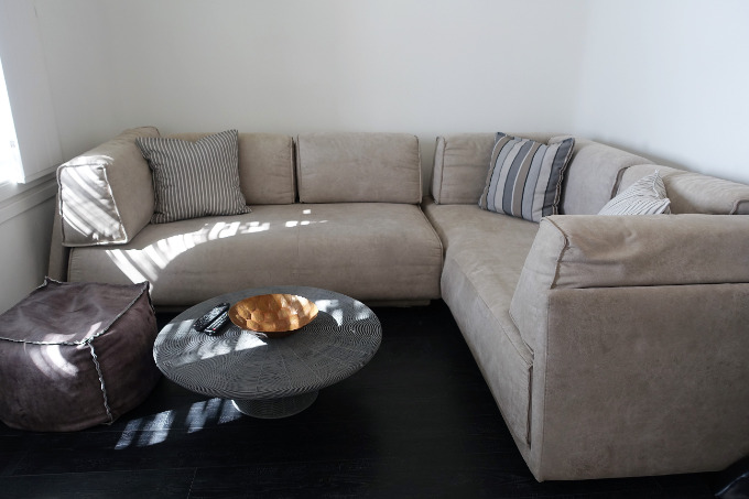 The open-plan suite's living area is spacious, and features a sectional sofa.