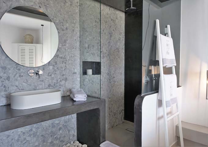 Some bathrooms feature pressed concrete while others have modern walls.