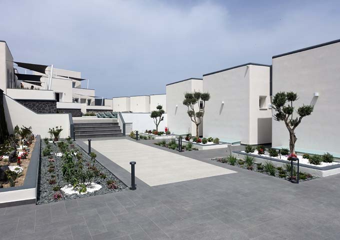 The courtyard features a small garden, and connects to the infinity pool.