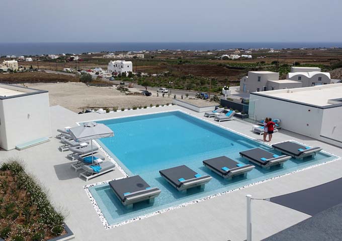 The hotel is located in the Tholos neighborhood, and there is a vineyard right in front of the pool.