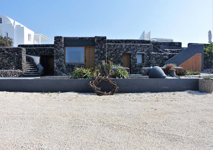 The reception area is built using lava rocks while the villas feature white Cycladic style.