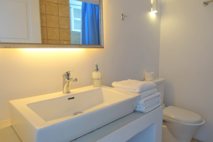 The bathroom is spacious with a mix of traditional architecture and modern amenities.