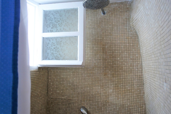 The hand-sculpted tiled shower reminds one of the traditional architecture.