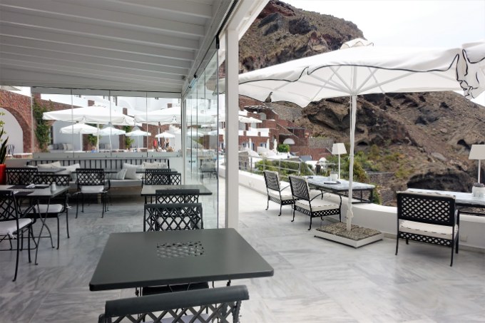 The restaurant and bar share tables, and overlook the caldera.