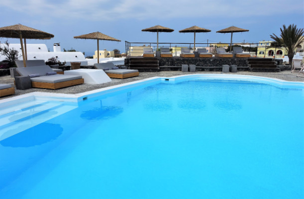 The pool deck features single and double sun loungers.