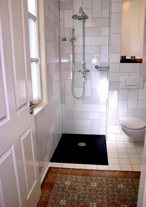 The small bathroom feature rain showers.