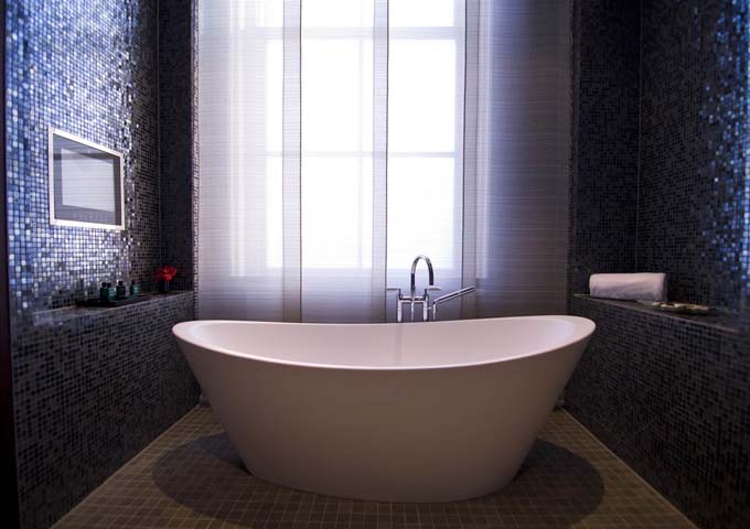 The Imperial Suite bathroom feature bathtubs and TVs.