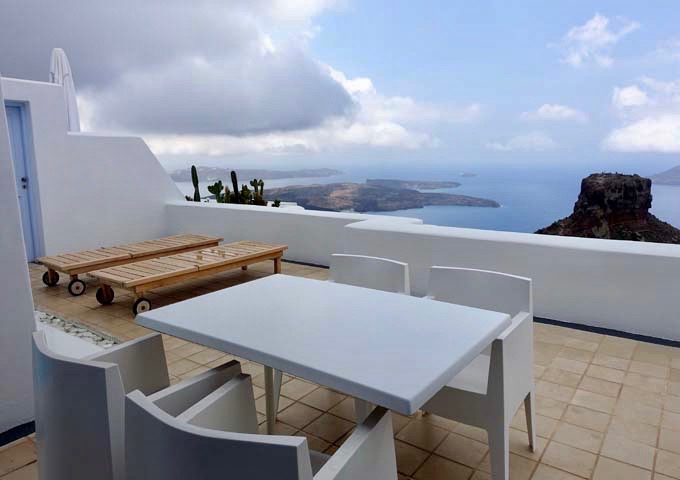 The suite's terrace is spacious, and features a dining table and sun loungers.