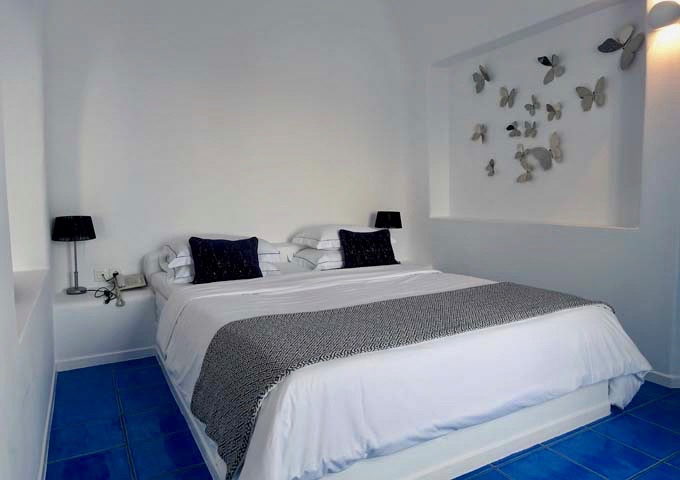 The bedroom features white and blue colors.