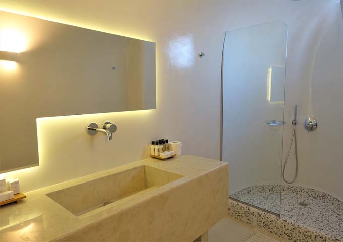 The second bathroom has a glass shower and marble vanity.
