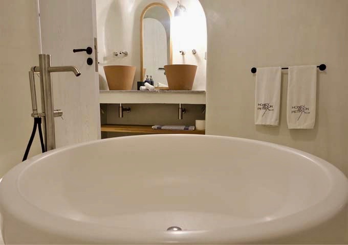 The round bathtub and dual terra cotta sinks are amazing.