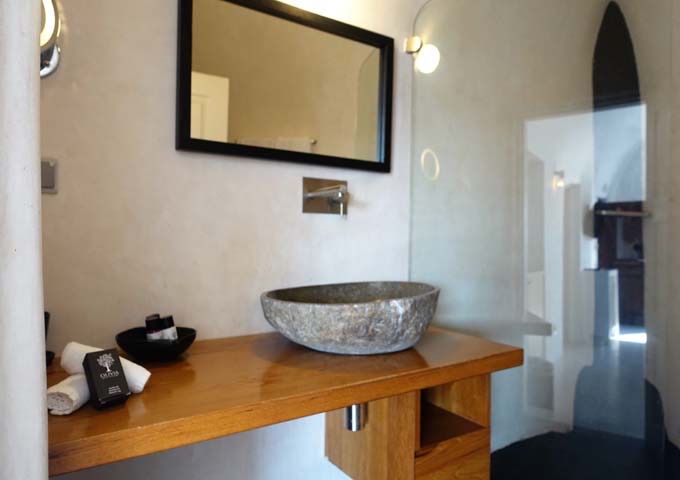The bathrooms are spacious and feature traditional cave-style design.