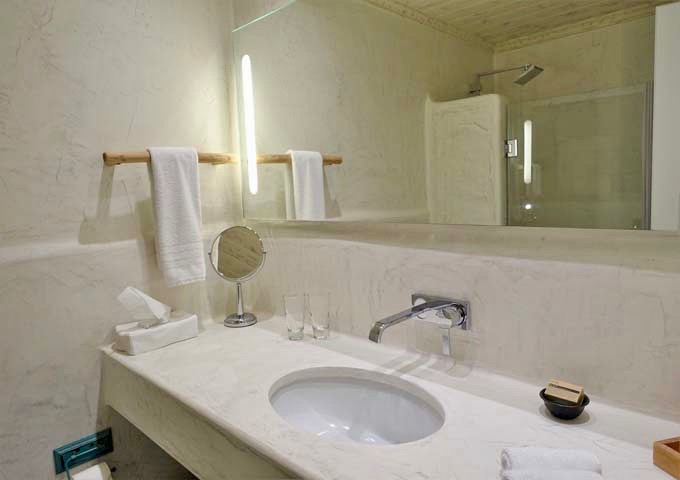 The Cycladic-style bathroom features pressed concrete and marble dust.