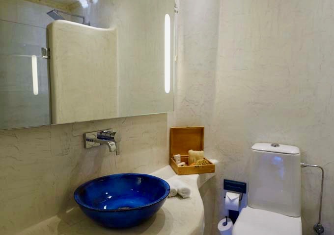 The bathroom has a traditional cave-style design.