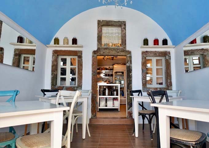 The restaurant features an open kitchen and traditional decor.