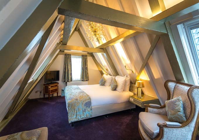 The top-floor Grand Suite feature heavy wooden beams and lofty views.