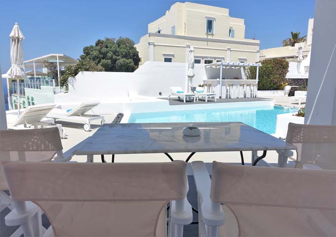 The suite's al fresco dining table overlooks the main pool.
