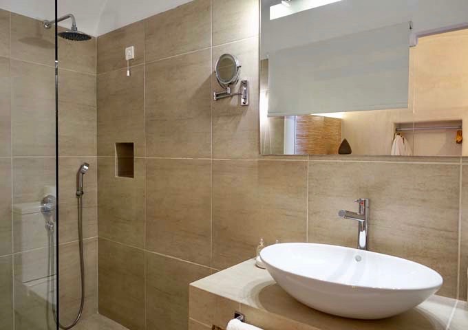 The suite bathrooms feature Greek-style, open rain showers.