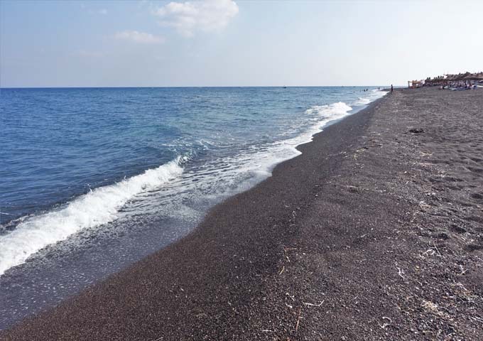 Perivolos is a clean black sand beach.