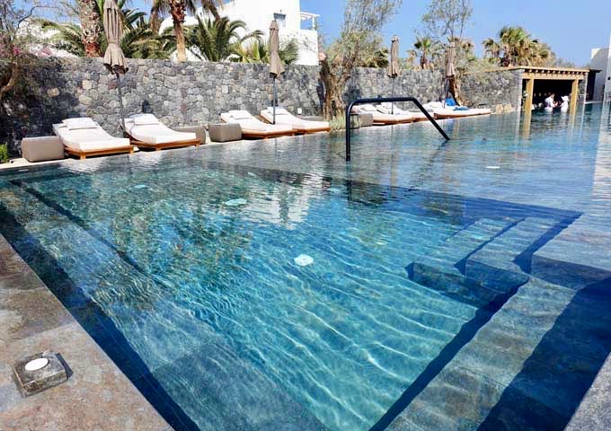 The pool has a large built-in jacuzzi at one end.