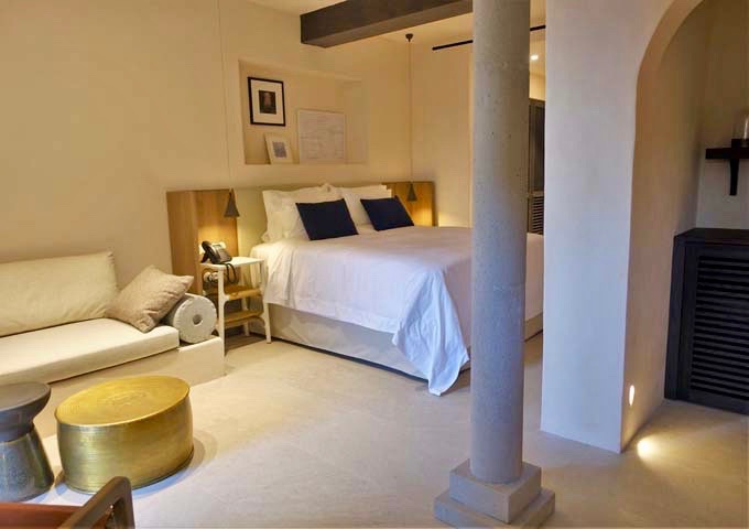 The Cycladic design of the suite is evident from the arched doorway and pressed concrete sofa and armrest.