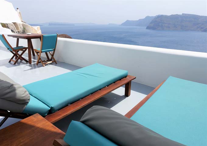 The suite's private terrace offers panoramic caldera views.