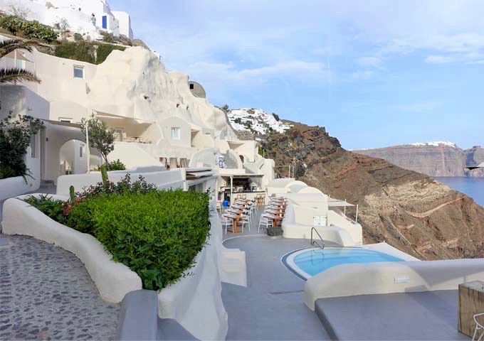 The hotel features traditional Cycladic style of architecture with hand-carved rooms.