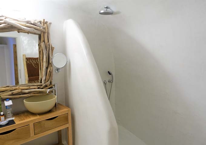 The ensuite bathroom has dual vanities and open shower.