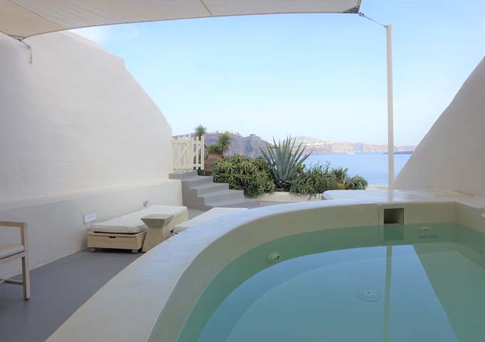 The suite's patio has an outdoor jacuzzi with caldera views.