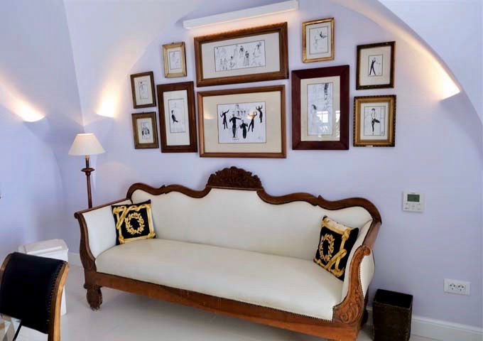 The sitting area features an antique sofa with Nureyev sketched hung over it.