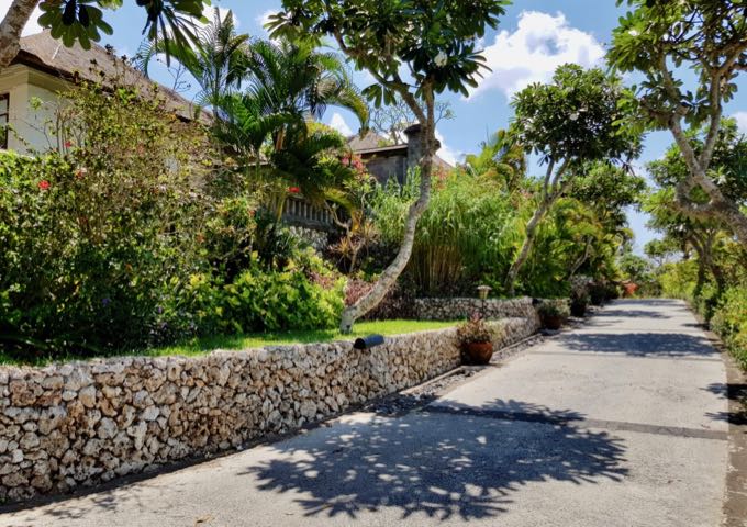 The villas are accessible via stone paths across the vast grounds.