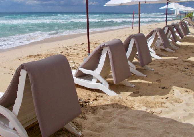 The beach features plenty of lounge chairs.