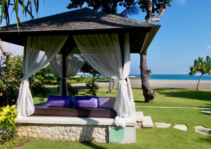 The lawns stretch up to the beach, and feature several massage huts.