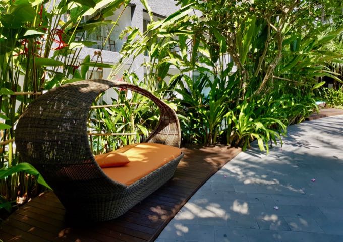 The small resort gardens feature comfortable lounge chairs.