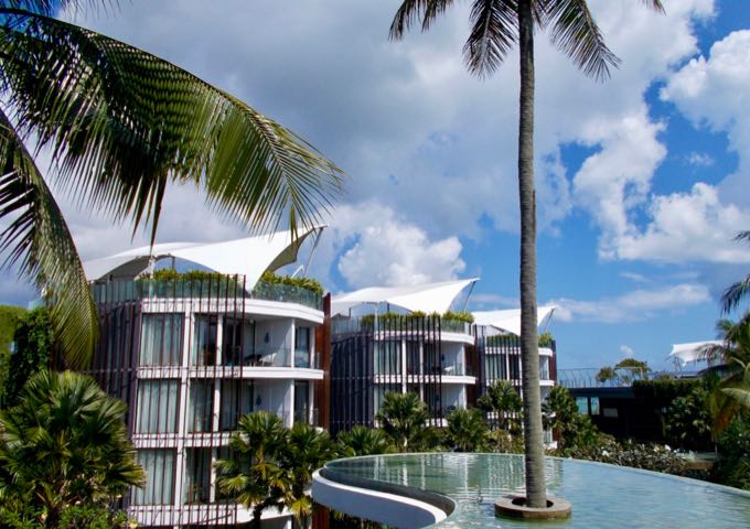 The resort lobby on the 3rd floor features a pond and a palm tree.