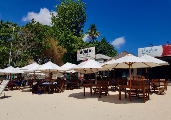 The popular Muaya Beach cafes are most crowded around sunset.