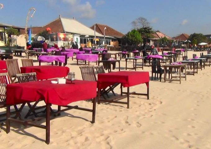 The seafood cafes set up tables on the Jimbaran beach for sunset dinners.