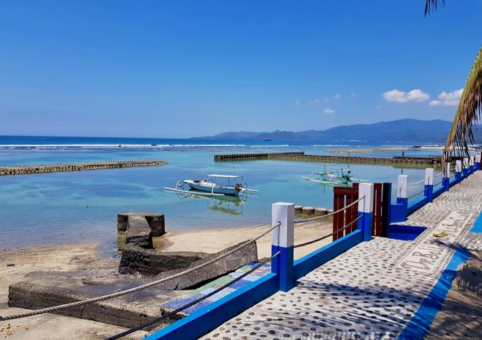 The raised walkway offers good views of the sea and distant mountains.