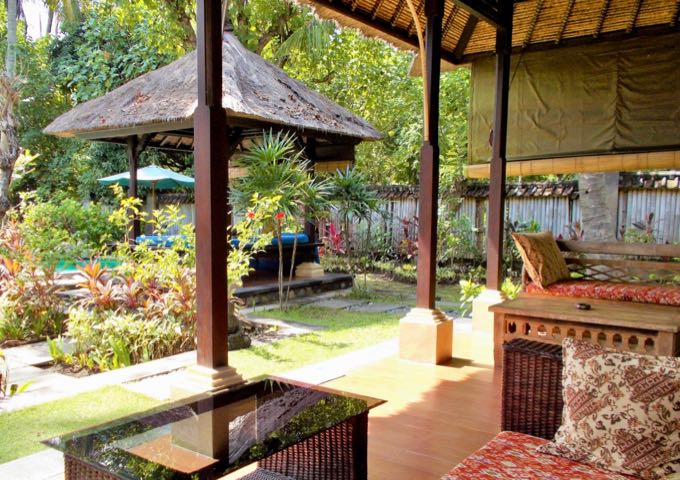 The private villa gardens feature open-air lounge areas.