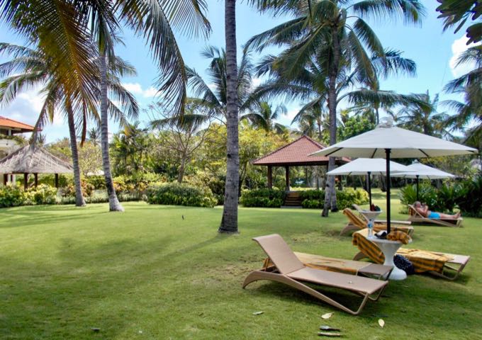 The shady gardens and lawns feature several lounge chairs.