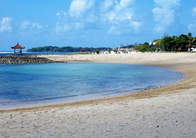 The cove in front of the resort has clean white sand and calm blue water.