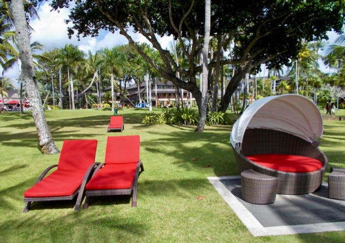 The resort has plenty of bright and inviting lounge chairs around its gardens.