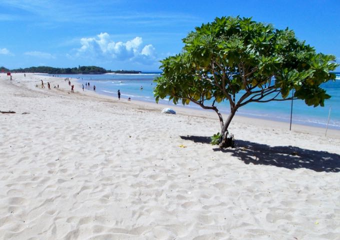 The resort beach features clean white sand and calm blue water.