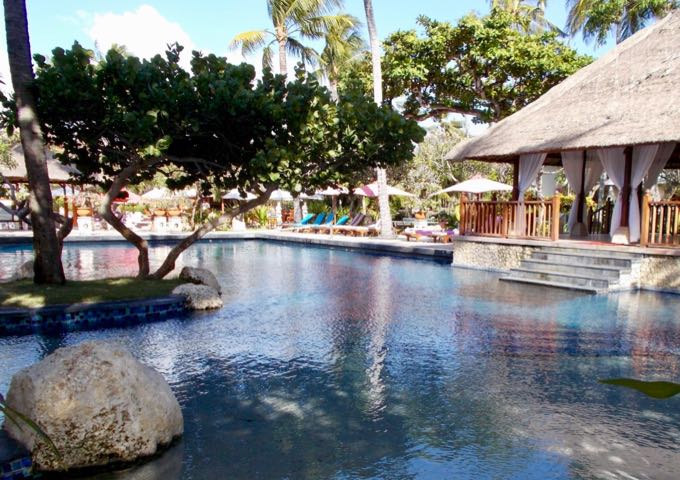 The large main pool has islands of palms.