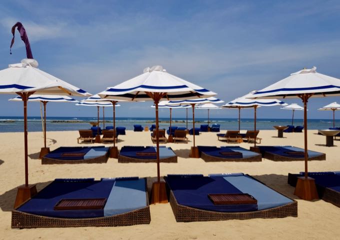 There are plenty of lounge chairs with umbrellas for guests to relax on.