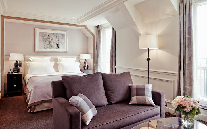 Hotel suite with sofa and coved ceilings