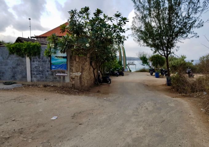 A poorly-paved road leads to the hotel.