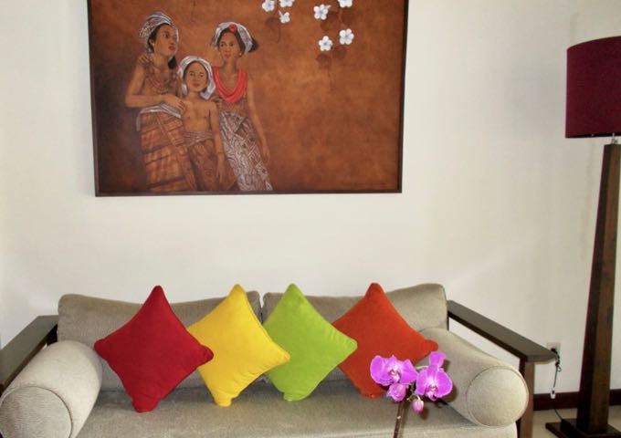 The rooms feature colorful wall art and cushions.