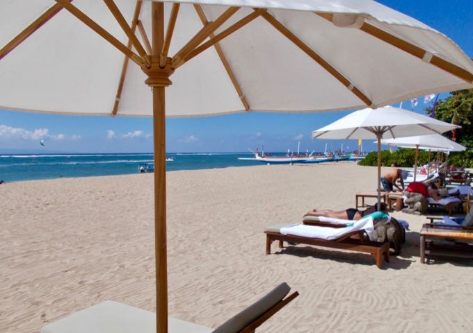 The scenic beach in front of the hotel has plenty of lounge chairs and umbrellas.